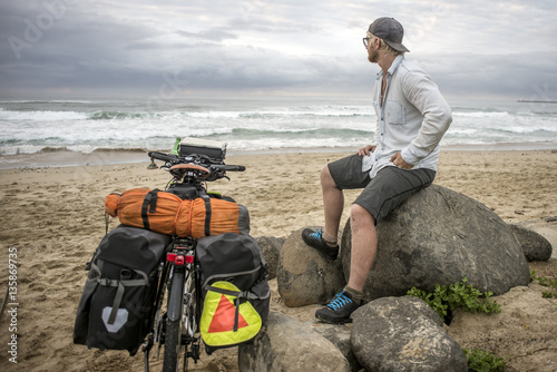 Long Distnace Cyclist with Bicycle on Beach