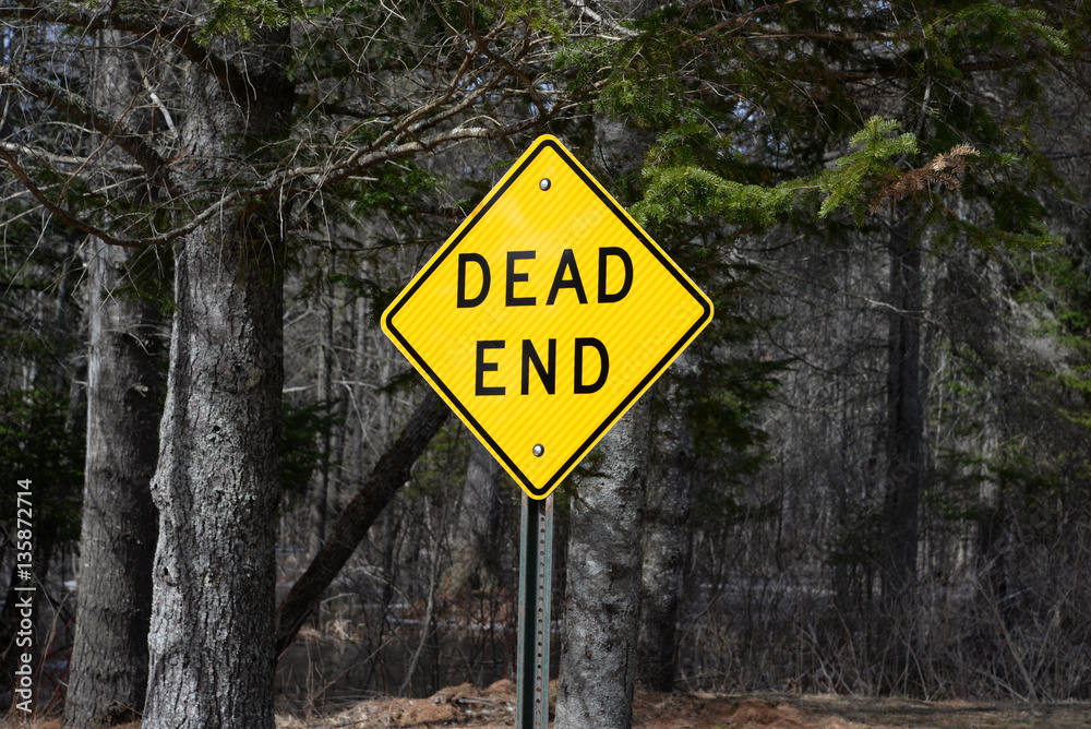 Dead end sign on dark lonely road