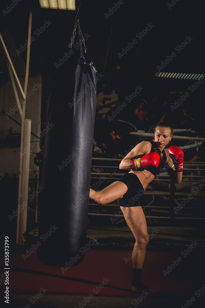 Girl in front of a training bag