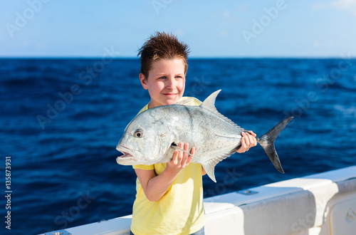 Boy deep sea fishing photo