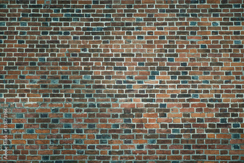 Old wall of red briks. Wallpaper of ordinary building wall texture.