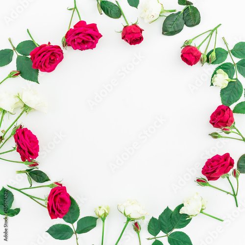 Round floral frame wreath pattern with roses, branches and leaves isolated on white background. Flat lay, top view