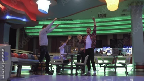 Friends playing and having fun at bowling game HD leisure video. Young man rolling throwing ball. Front view from alley. Hobby and competitions