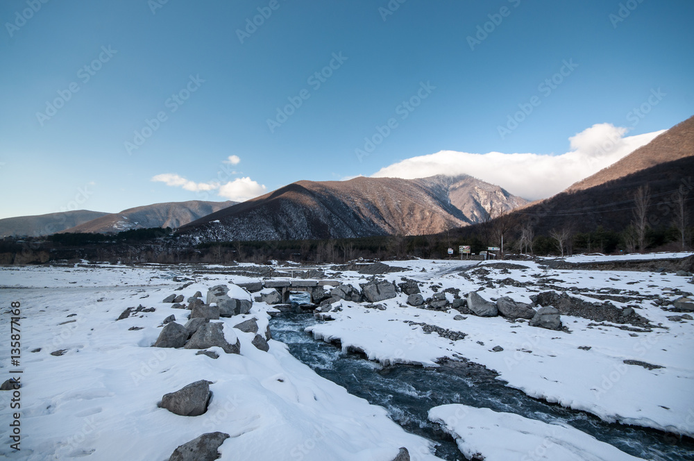 Obraz premium Beautiful Landscape of snowy winter greater Caucasus mountains. Sunny weather, trees clouds fields of Azerbaijan nature