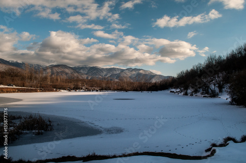 Landscape with a frozen duck lake and mountains of big Caucasus at Sheki, Azerbaijan