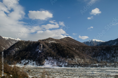 Beautiful Landscape of snowy winter greater Caucasus mountains. Sunny weather, trees clouds fields of Azerbaijan nature © zef art