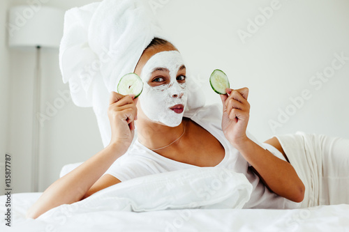 Teenage girl making facial mask