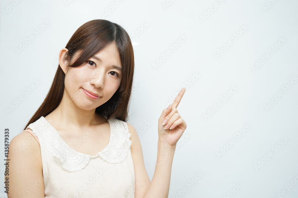 Young woman pointing something with white background Young woman pointing something with white background