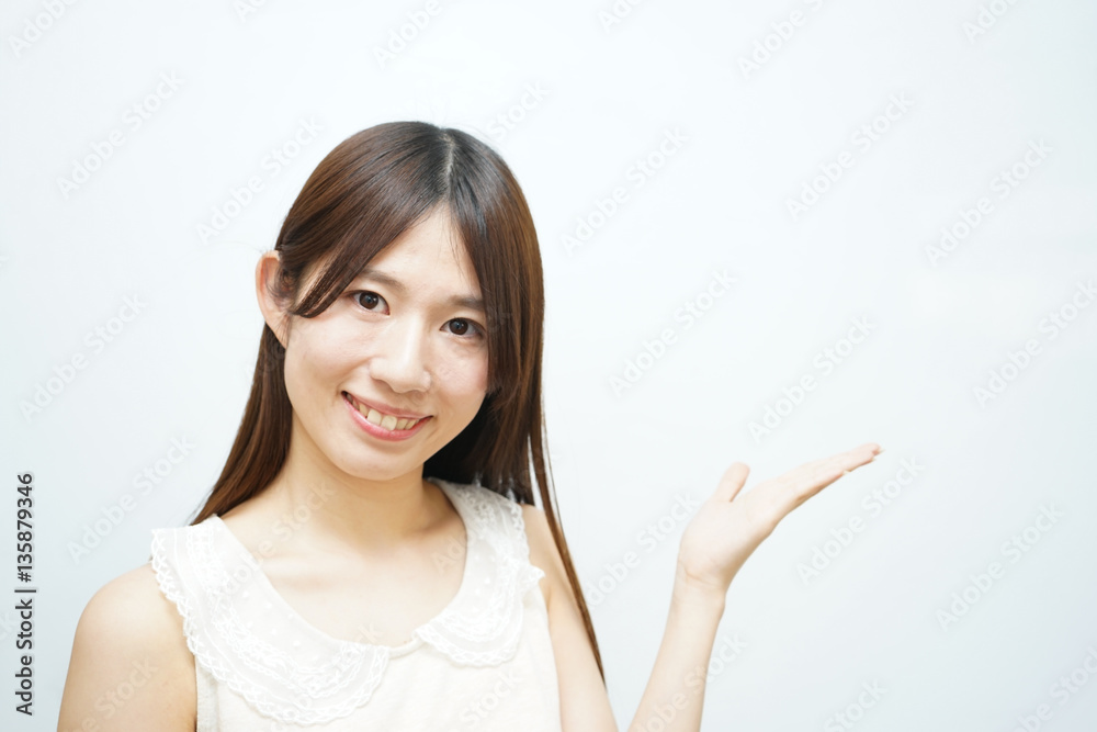 Young woman pointing something with white background Young woman pointing something with white background
