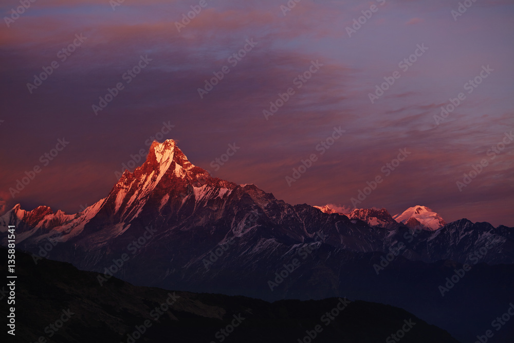 Calm and peaceful scenic view of double summit of Machapuchare resembling fishtail rising over valley in the Annapurna Himalayas of north central Nepal. Nature, mountaineering, highlands and altitude