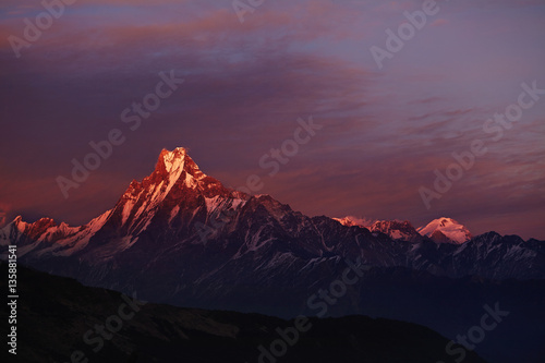 Calm and peaceful scenic view of double summit of Machapuchare resembling fishtail rising over valley in the Annapurna Himalayas of north central Nepal. Nature  mountaineering  highlands and altitude