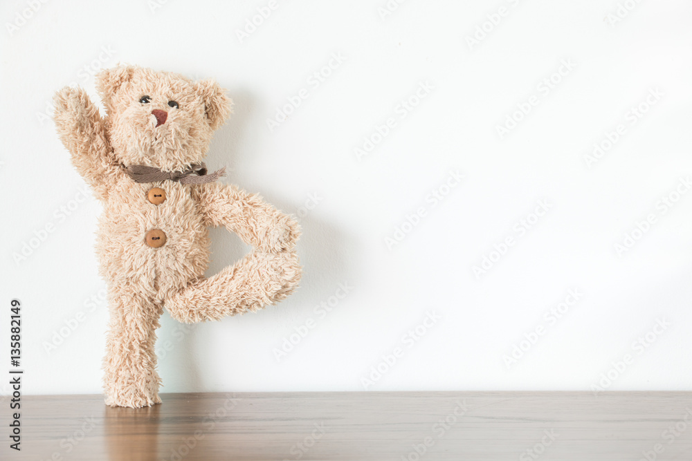 Teddy bear is an exercise with yoga and warm body Stock Photo