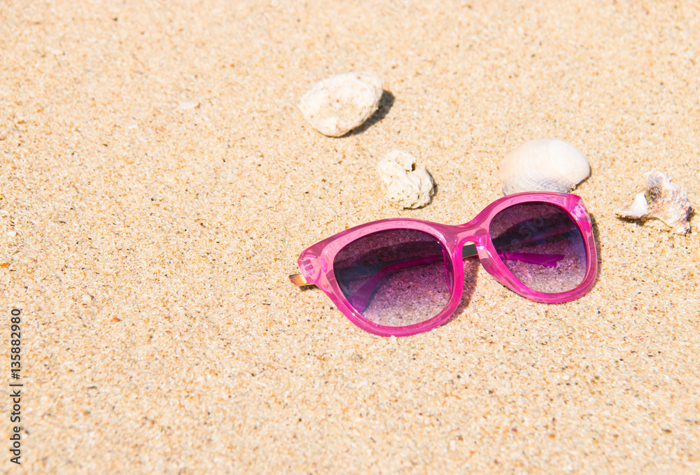 summer pink sunglasses and white sand