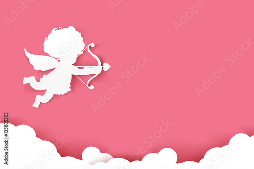 Cupid holding arrow with shadow on pink background with copyspac photo