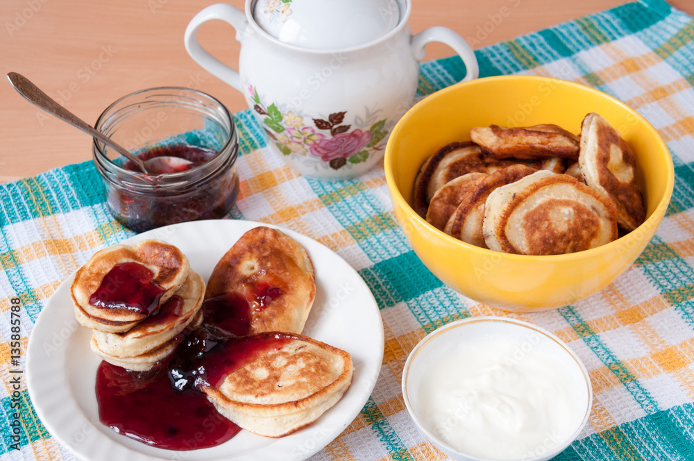 Pancakes for breakfast with cherry jam and sour cream Pancakes for breakfast with cherry jam and sour cream