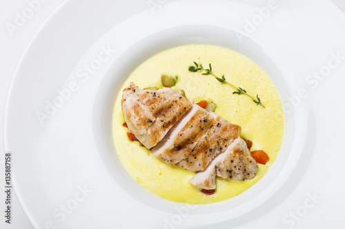 Cream soup with chicken on white background