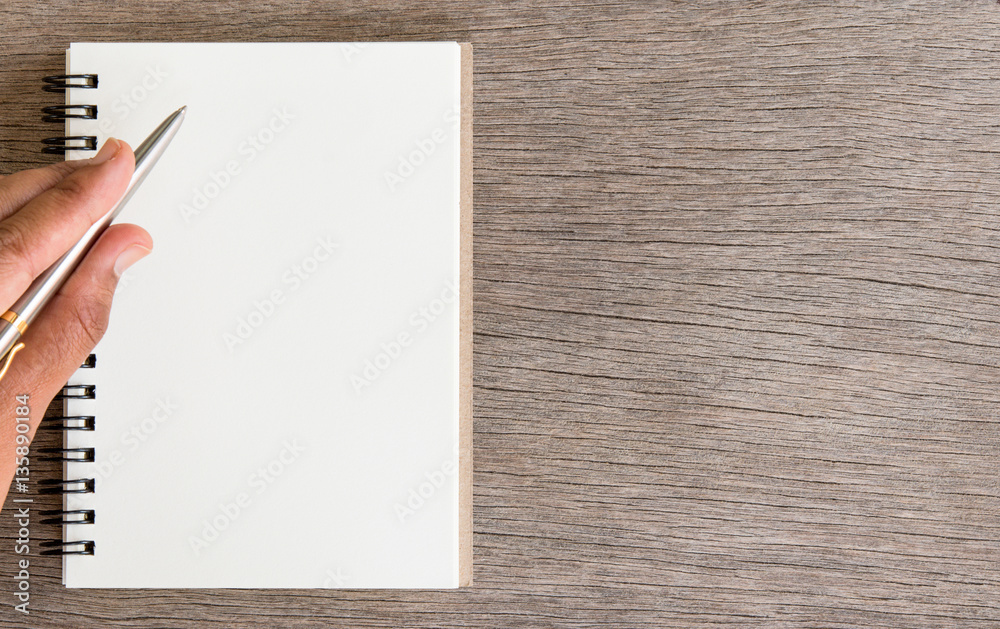 Left Hand Writing, Blank Notebook on Wooden Desk Left Hand Writing, Blank Notebook on Wooden Desk