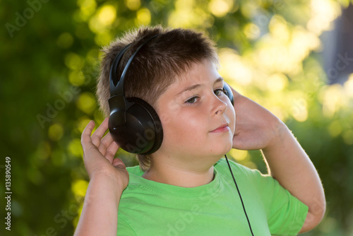 Portrait of boy with headphones outdoors