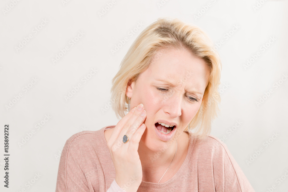 Blonde Woman in Pain Touching Cheek Blonde Woman in Pain Touching Cheek