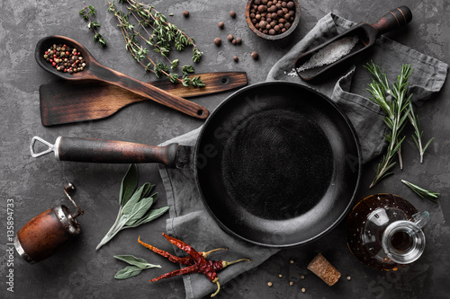 dark culinary background with empty black pan and space for text recipe or menu photo