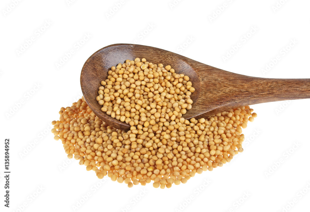 Mustard seeds in wooden spoon isolated on white background