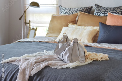 modern bedroom interior with vintage handbag on the bed