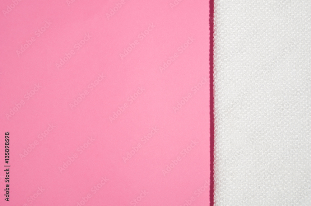 Fototapeta premium White towel on a geometric modern pink paper background top view with copy space
