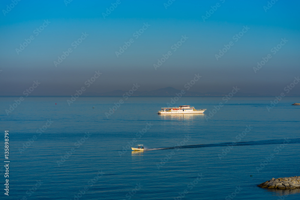 Boat on a blue ocean with a clear blue sky.