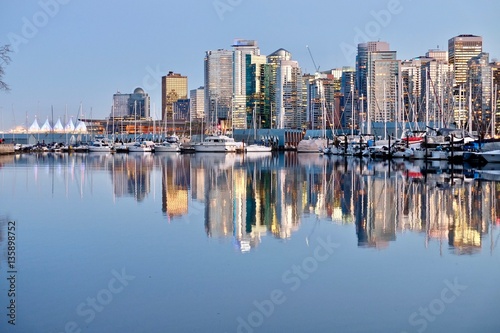 Vancouver Skyline and reflection in calm water. Coal Harbor. View from Stanley Park. West End. Downtown Vancouver. British Columbia. Canada.