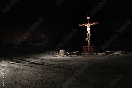 Krzyż z wizerunkiem Chrystusa na polach zimą. photo