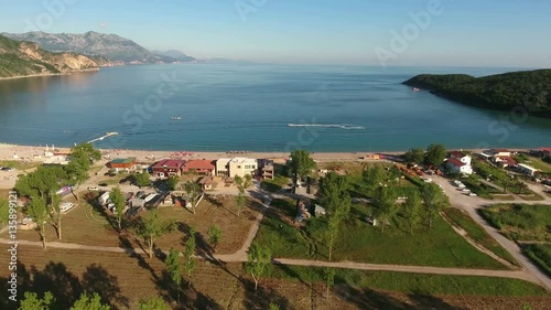 Hinterland of the Jaz beach with camping area. Popular beach for sunbathing in Budva municipality. Montenegro. Aerial view
