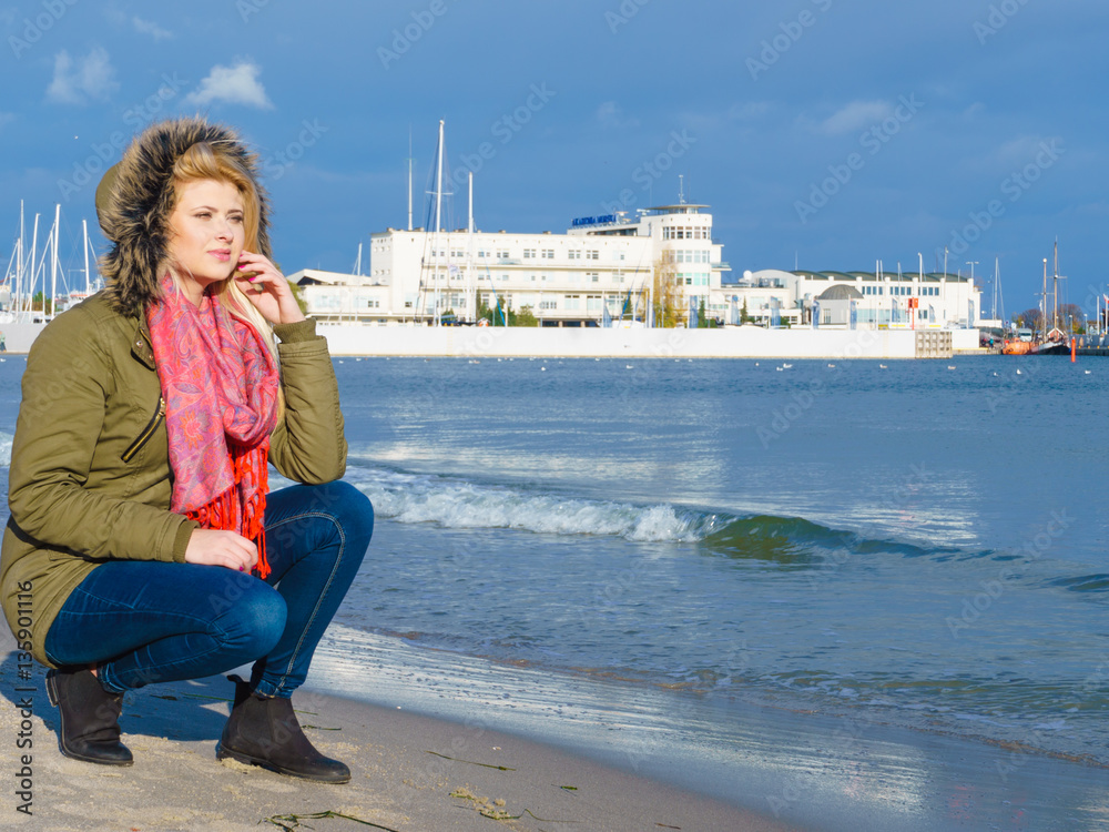 Woman relaxing on beach, cold day