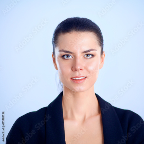 A young woman standing, isolated on gray background