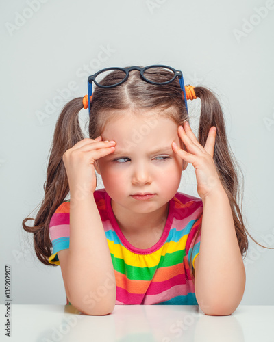 Photos unhappy beautiful cute little girl sulking and thinking