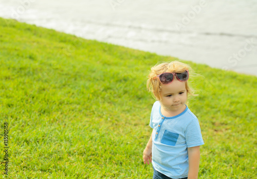 Cute baby boy with fashionable sunglasses on head