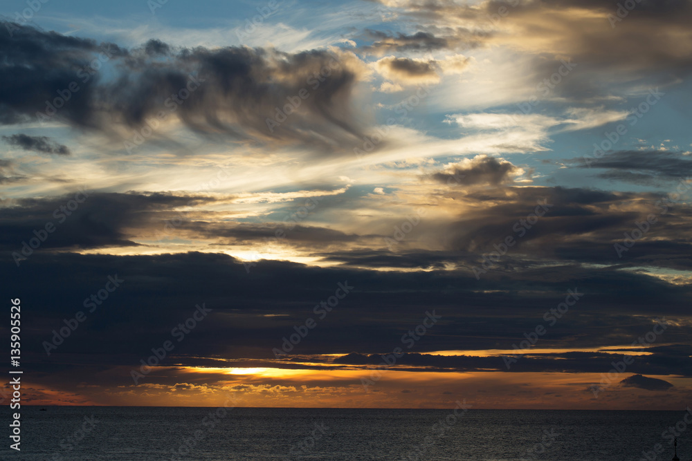 Dramatic evening sky with dark clouds over sea