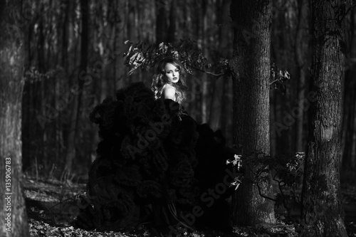 elegant young woman in forest