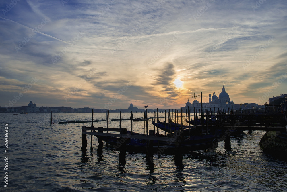 Venice lagoon sunset with gondolas