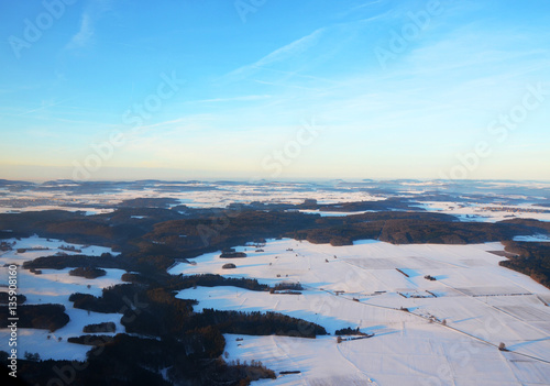 Aerial view of snowy south germany on a sunny winter day between the Swabian Alps and Ulm