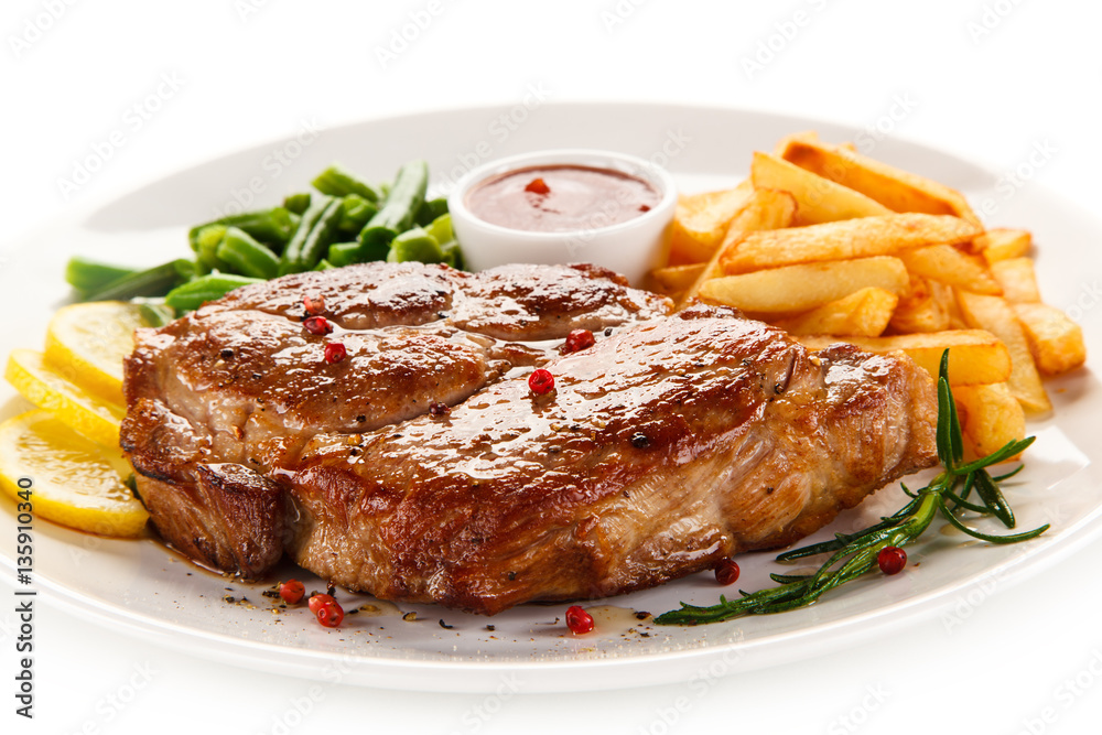 Grilled steak, French fries and vegetables 