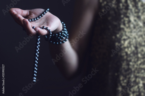 woman with pearls in her hand
