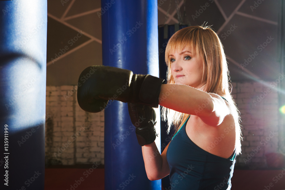 Young woman boxing workout in gym