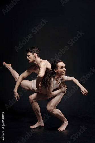 Beautiful strong gymnasts performing together in the studio
