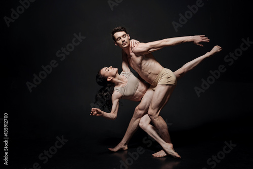 Obraz na plátně Young involved ballet dancers performing in the studio