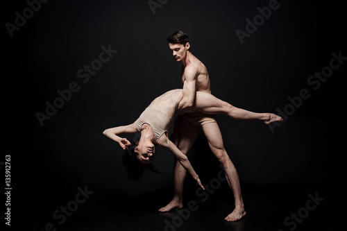 Masterful young performers acting against black background