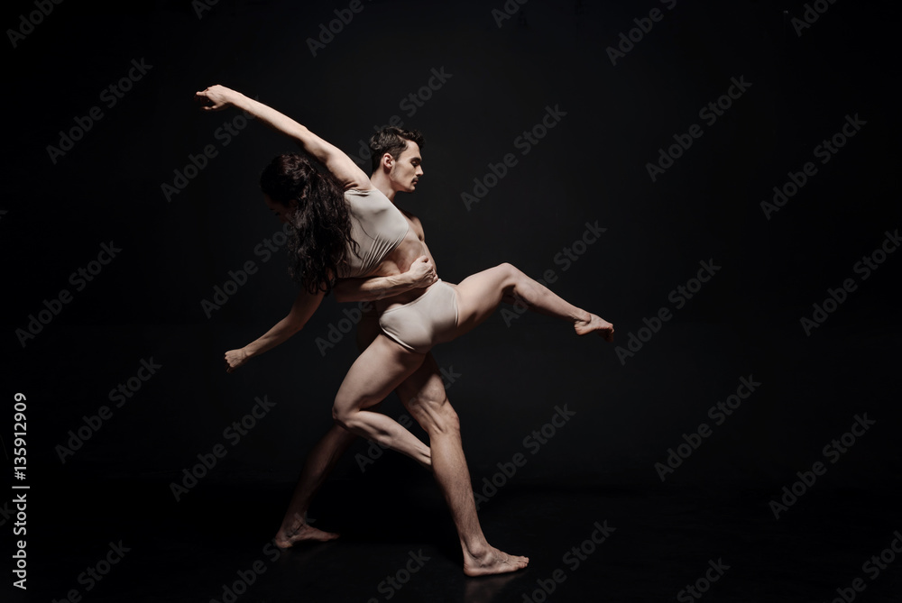 Inventive young dance couple taking part in the art performance