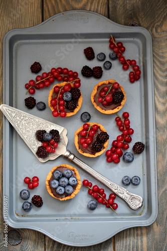 mini tarts with fresh berries and chocolate ganache photo