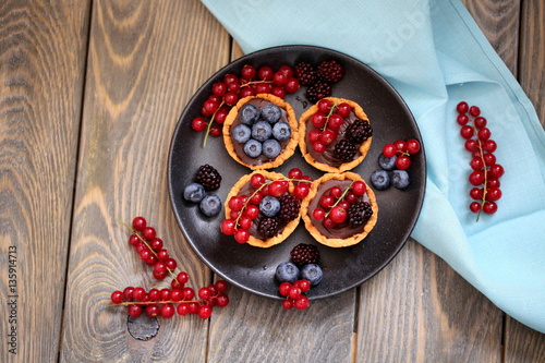 mini tarts with fresh berries and chocolate ganache