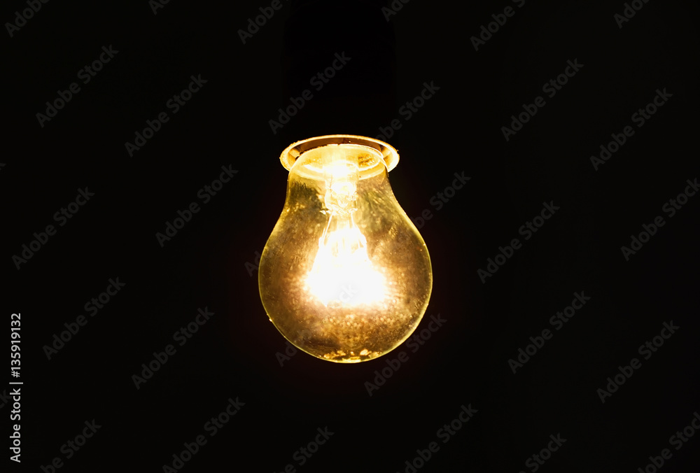 light bulb shines a bright light, soft focus light bulb shines a bright light, soft focus