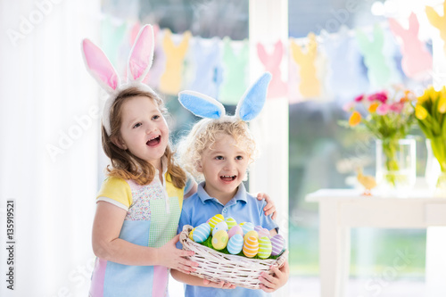 Kids with eggs basket on Easter egg hunt